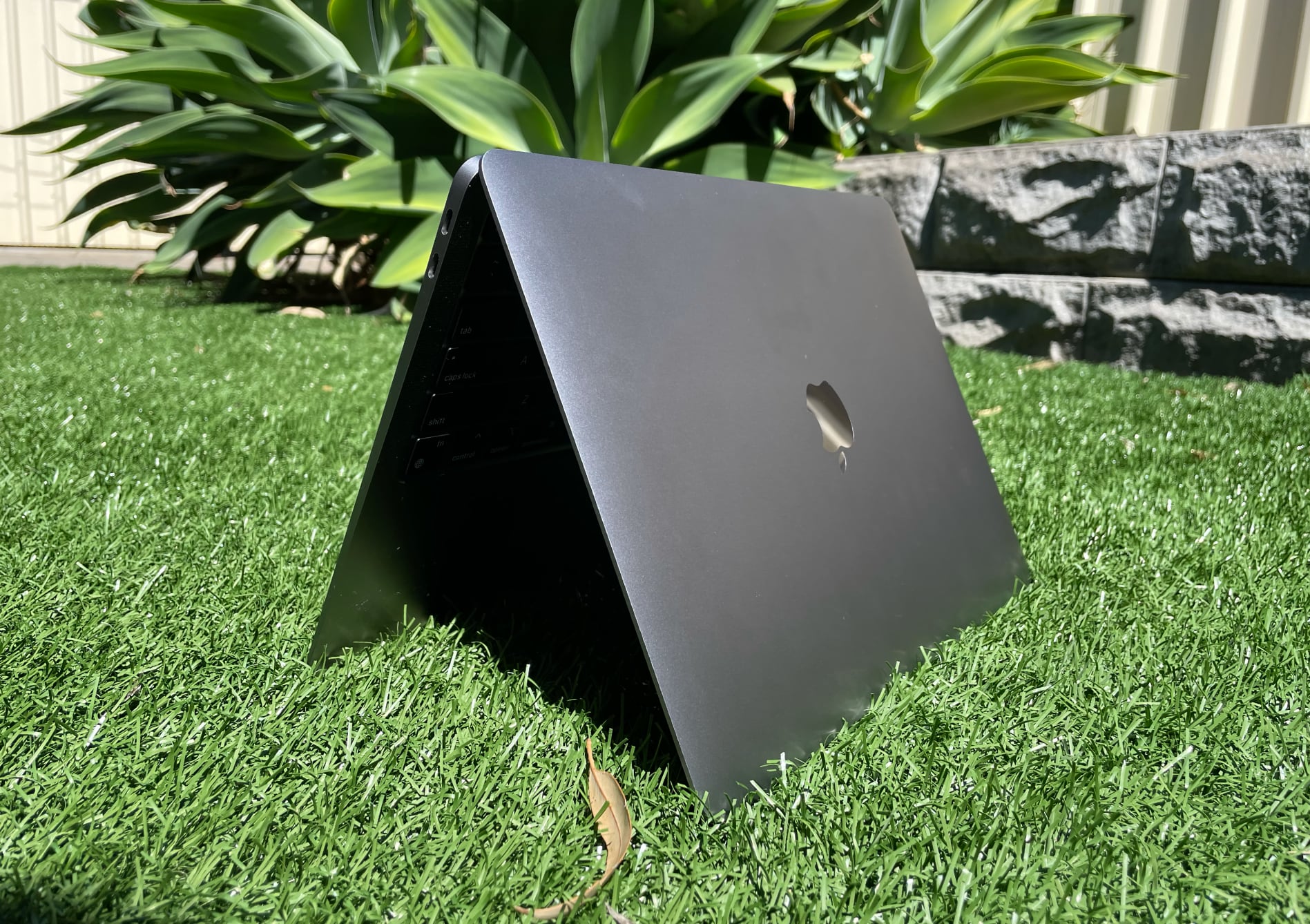 MacBook Air in tent formation on some grass